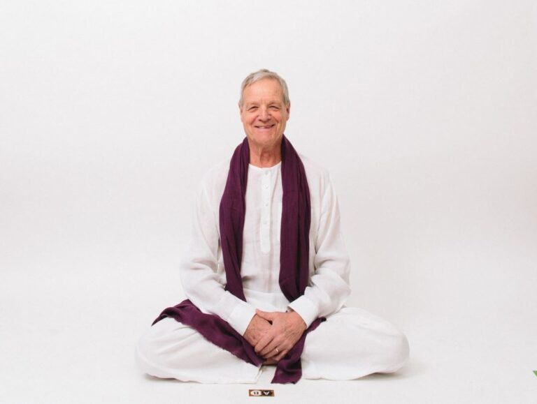 Peter Riedl vor weisser Wand Meditation praktizierend WISDOM Achtsamkeit